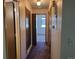 Neutral-colored hallway with doors, carpet, and light fixture at 10872 W Evans Ave # 2E, Lakewood, CO 80227