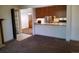 Kitchenette featuring a breakfast bar, sink and dark wood cabinets at 10872 W Evans Ave # 2E, Lakewood, CO 80227