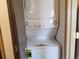 Stacked laundry closet with standard-sized white washer and dryer combo at 10872 W Evans Ave # 2E, Lakewood, CO 80227