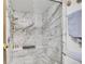 Modern shower with marble surround, built-in seat, and multiple shower heads at 10872 W Evans Ave # 2E, Lakewood, CO 80227