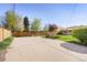 Spacious backyard featuring a concrete pad, mature trees, and a well-maintained fence for privacy at 2801 N Garfield St, Denver, CO 80205
