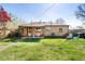 Expansive backyard showcasing a well-maintained lawn, a covered patio, and ample space for outdoor activities at 2801 N Garfield St, Denver, CO 80205