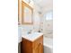 Bathroom featuring tiled walls, vanity with storage, and shower/tub combo at 2801 N Garfield St, Denver, CO 80205