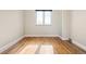 Empty bedroom featuring a light-filled room, hardwood floors, and built-in shelving at 2801 N Garfield St, Denver, CO 80205