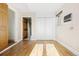 Bright bedroom featuring hardwood floors, double door closet, and natural light streaming in through the window at 2801 N Garfield St, Denver, CO 80205