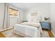 Inviting bedroom featuring soft textures, light-colored walls, hardwood floors, and plenty of natural light at 2801 N Garfield St, Denver, CO 80205