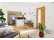 Open-concept dining area with modern light fixture, hardwood flooring, and seamless flow to kitchen at 2801 N Garfield St, Denver, CO 80205