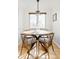 Cozy dining nook features hardwood flooring, a modern chandelier, and sunlit window at 2801 N Garfield St, Denver, CO 80205