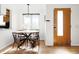 Dining area with hardwood floors, a modern light fixture, and natural light from the window at 2801 N Garfield St, Denver, CO 80205