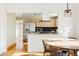 Open floor plan showcasing dining area, kitchen with stainless steel appliances and light wood cabinetry at 2801 N Garfield St, Denver, CO 80205