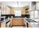 Bright kitchen featuring stainless appliances, granite countertops, and light wood cabinetry at 2801 N Garfield St, Denver, CO 80205