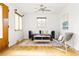 Bright and modern living room with hardwood floors, a ceiling fan and natural light at 2801 N Garfield St, Denver, CO 80205
