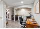 Finished basement featuring a bar with cabinets and a wine cooler, plus an adjacent study space at 13850 Meadowbrook Dr, Broomfield, CO 80020