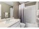 Bathroom featuring a vanity with a single sink, toilet, and a shower/tub with an ombre shower curtain at 13850 Meadowbrook Dr, Broomfield, CO 80020