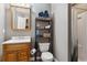 Bathroom featuring a vanity, toilet, and shower/tub with a dark wood shelving unit next to the toilet at 13850 Meadowbrook Dr, Broomfield, CO 80020