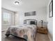 Bedroom with a metal bed frame, carpeted floors, and a light-wood side table with a lamp at 13850 Meadowbrook Dr, Broomfield, CO 80020