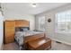Bedroom with hardwood furniture, two windows, and a grey patterned bedspread at 13850 Meadowbrook Dr, Broomfield, CO 80020