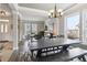 Bright dining room leading to living room with large window and hardwood floors at 13850 Meadowbrook Dr, Broomfield, CO 80020