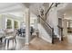 Bright entryway with staircase, and adjacent formal dining room with large windows at 13850 Meadowbrook Dr, Broomfield, CO 80020