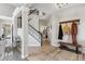Inviting entryway with tile flooring, staircase and hall tree with bench at 13850 Meadowbrook Dr, Broomfield, CO 80020