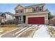 Charming home featuring a red garage door, complementing the red shutters at 13850 Meadowbrook Dr, Broomfield, CO 80020