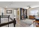 Upstairs hallway with hardwood floors, black railing, and a large bookshelf with rolling ladder at 13850 Meadowbrook Dr, Broomfield, CO 80020