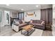 Finished living room featuring couches, a coffee table, an accent wall, and a small eating area at 13850 Meadowbrook Dr, Broomfield, CO 80020