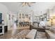 Open concept living room with hardwood flooring, adjacent to the kitchen and entryway at 13850 Meadowbrook Dr, Broomfield, CO 80020