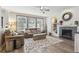 Cozy living room with a fireplace, ample seating and bright natural light at 13850 Meadowbrook Dr, Broomfield, CO 80020