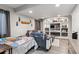Basement living room with a bed, built-in bookshelves, and a large grey couch at 13850 Meadowbrook Dr, Broomfield, CO 80020