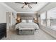 Main bedroom features a wood accent wall, neutral color palette and a large window at 13850 Meadowbrook Dr, Broomfield, CO 80020