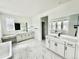 Spacious bathroom features dual vanities, soaking tub, marble floors, and contemporary fixtures for a spa-like experience at 16521 Black Rose Cir, Parker, CO 80134