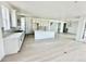 Bright, spacious kitchen features white cabinets, an island, modern appliances, and an open floor plan at 16521 Black Rose Cir, Parker, CO 80134