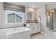 Modern bathroom with a soaking tub and double sinks at 9354 Quartz St, Arvada, CO 80007