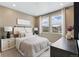 Cozy bedroom with a large window, natural light, and neutral-colored walls at 9354 Quartz St, Arvada, CO 80007