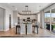 A stylish dining area features a dark wood table with seating for six, set in an open concept at 9354 Quartz St, Arvada, CO 80007