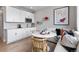 A dining area with modern furniture and a breakfast nook is adjacent to the kitchen area at 9354 Quartz St, Arvada, CO 80007