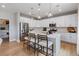 A contemporary kitchen with stainless steel appliances, a center island, and stylish pendant lighting at 9354 Quartz St, Arvada, CO 80007