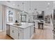 A bright, open floor plan seamlessly connects the kitchen, dining area, and living room with sliding glass doors at 9354 Quartz St, Arvada, CO 80007