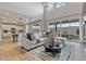 Bright living room featuring high ceilings, large windows, dining area, and wood floors at 9354 Quartz St, Arvada, CO 80007
