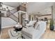 Bright living room featuring high ceilings, staircase, dining area, and wood floors at 9354 Quartz St, Arvada, CO 80007