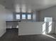 Open loft area with carpeting, neutral walls, railing, and an abundance of natural light from large windows at 9354 Quartz St, Arvada, CO 80007