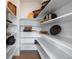 A well-organized pantry with multiple shelves provides ample storage space for groceries and kitchen essentials at 9354 Quartz St, Arvada, CO 80007