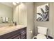 Bathroom with granite countertop vanity, decorative mirror, and tiled floors at 19827 E Prentice Ave, Centennial, CO 80015