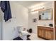 Well-lit bathroom with a wooden vanity and classic fixtures at 19827 E Prentice Ave, Centennial, CO 80015