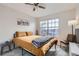 Bright bedroom with a large window, ceiling fan, and mountain artwork above the bed at 19827 E Prentice Ave, Centennial, CO 80015