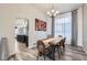 Elegant dining room featuring modern lighting, wood table, and view into the kitchen at 19827 E Prentice Ave, Centennial, CO 80015