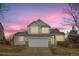 Charming two-story home with neutral siding, a two-car garage, and a manicured lawn at 19827 E Prentice Ave, Centennial, CO 80015