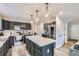 Modern kitchen with stainless steel appliances, a center island, and stylish pendant lighting at 19827 E Prentice Ave, Centennial, CO 80015