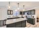 Well-equipped kitchen featuring stainless steel appliances, a large island, and modern lighting fixtures at 19827 E Prentice Ave, Centennial, CO 80015